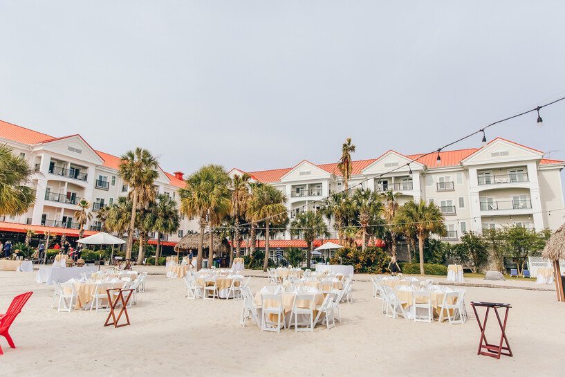 a group of tables and chairs in front of a white building