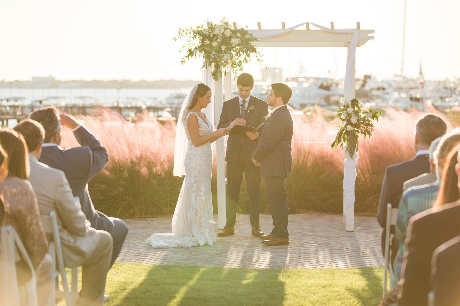 a bride and groom under a wedding arch