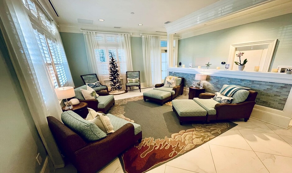 a room with a couch and chairs