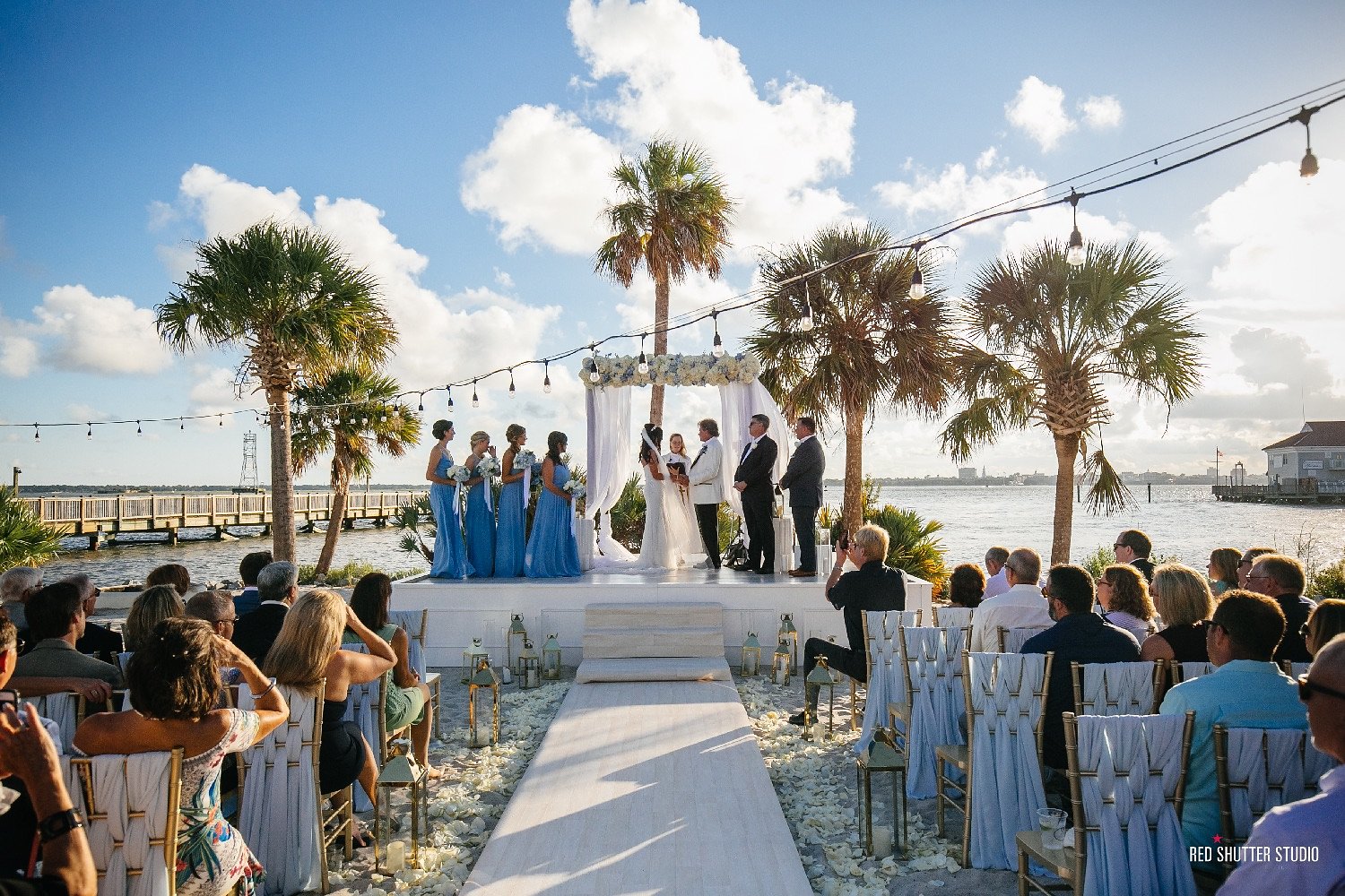 a group of people under a wedding arch